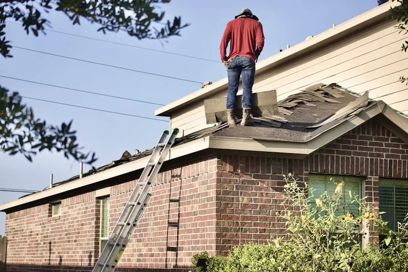 Professional roofer working on a residential roof in Holiday Meadows